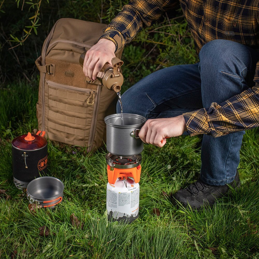 individual-camping-pot-burner-use Individual camping pot on burner pouring water